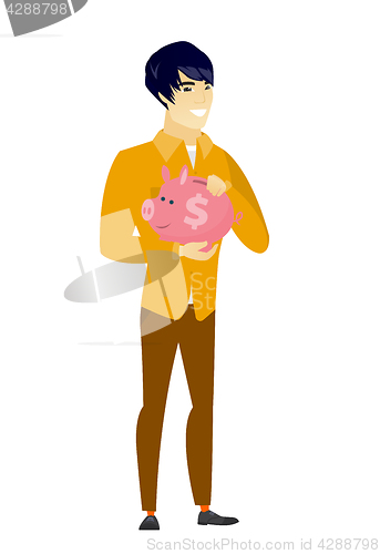 Image of Asian business man holding a piggy bank.