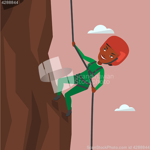 Image of Woman climbing in mountains with rope.