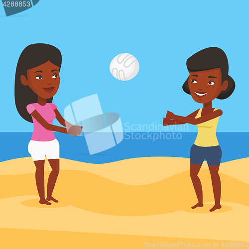 Image of Two women playing beach volleyball.