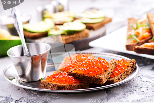 Image of bread with red salmon caviar 