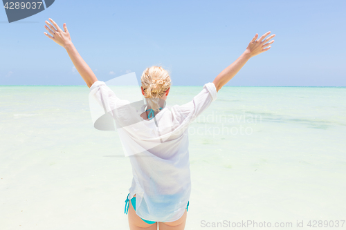 Image of Happy woman enjoying, relaxing joyfully in summer on tropical beach.