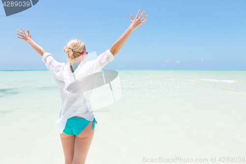 Image of Happy woman enjoying, relaxing joyfully in summer on tropical beach.