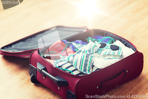 Image of close up of travel bag with beach clothes