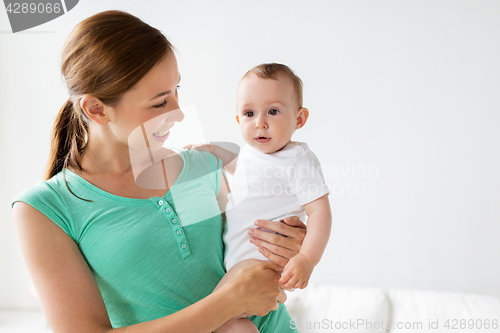 Image of happy young mother with little baby at home