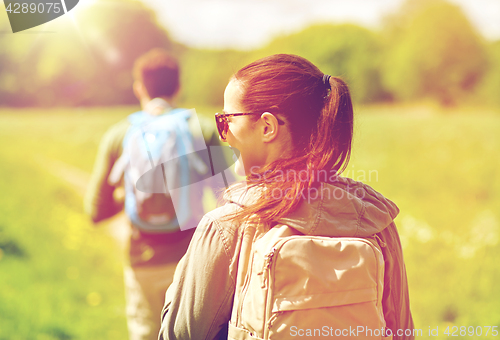 Image of close up of couple with backpacks hiking outdoors