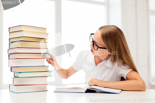 Image of student girl in glasses with books at school