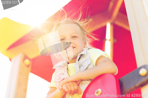 Image of happy little girl on children playground