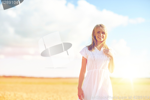 Image of happy young woman or teenage girl on cereal field