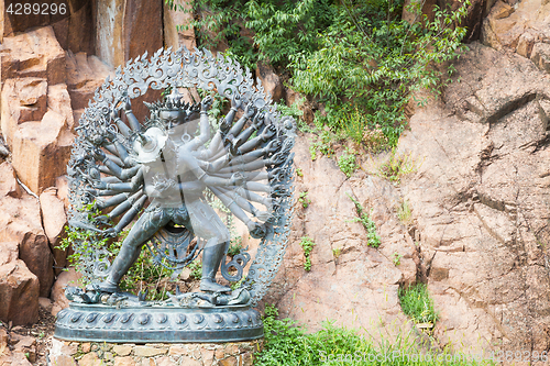 Image of Tantric Deities statue in Ritual Embrace located in a mountain g