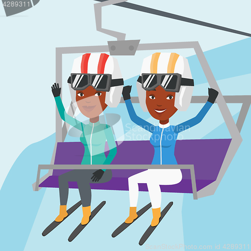 Image of Two happy skiers using cableway at ski resort.