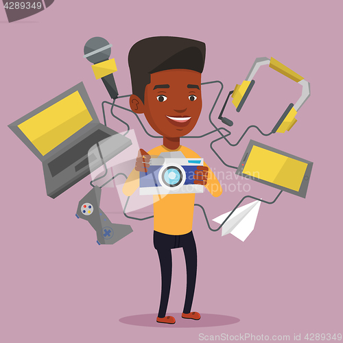 Image of Young man surrounded with his gadgets.