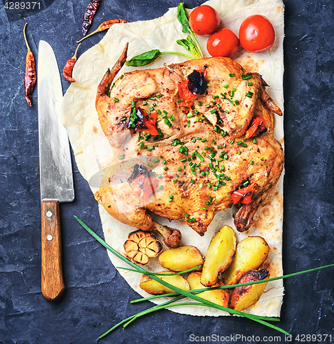 Image of Baked chicken with potatoes on pita