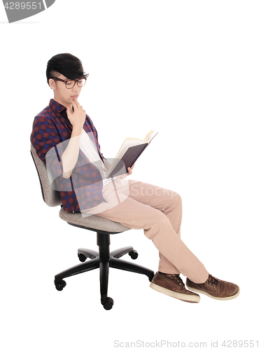 Image of Asian man reading a book.