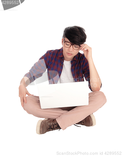 Image of Young Asian teen with laptop.