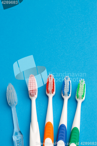 Image of Photo of five multi-colored toothbrush