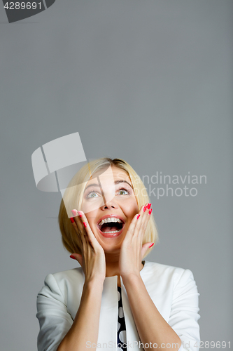 Image of Surprised happy girl looking up