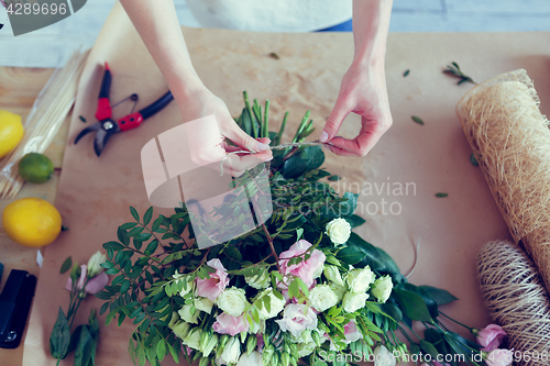 Image of Florist makes composition of flowers