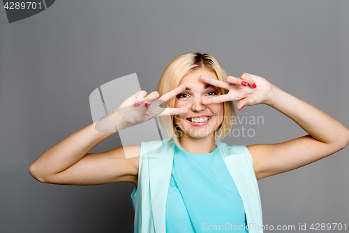 Image of Girl with fingers at eyes