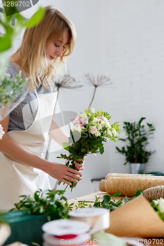 Image of Young blonde in flower shop