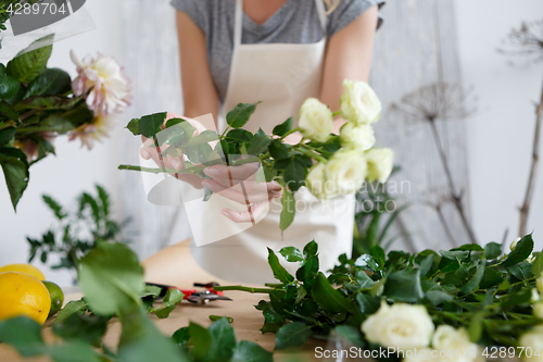 Image of Young florist woman with flowers