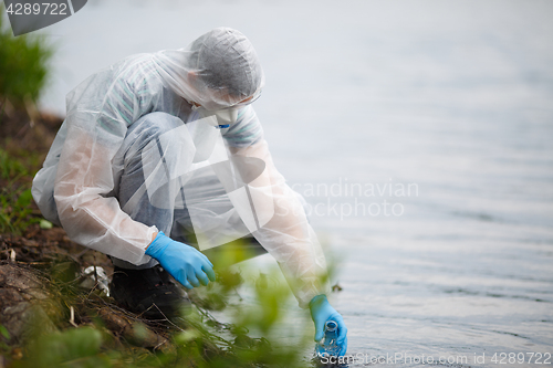 Image of Ecologist takes sample of water