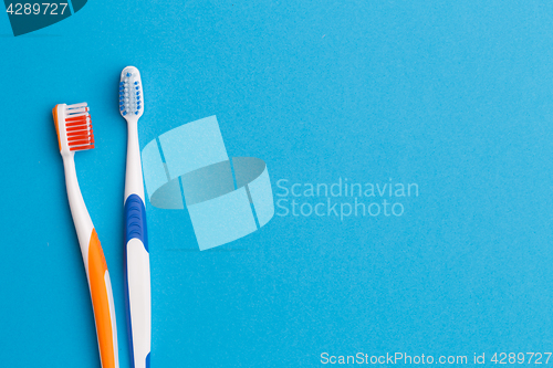 Image of Two toothbrushes , space for text