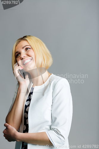 Image of Beautiful woman talking on phone