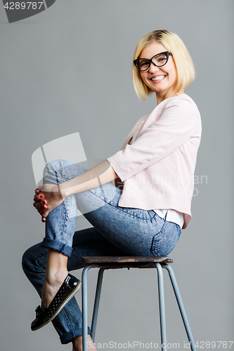 Image of Girl in glasses on chair