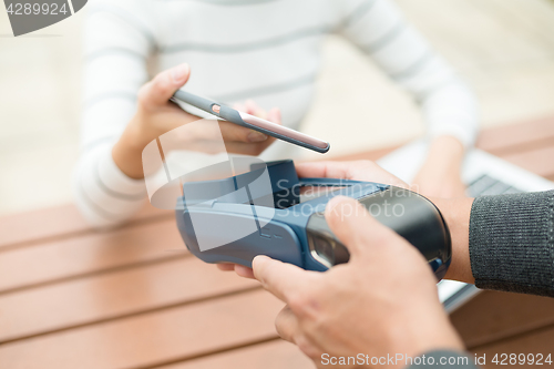 Image of Paying with smartphone on pos terminal