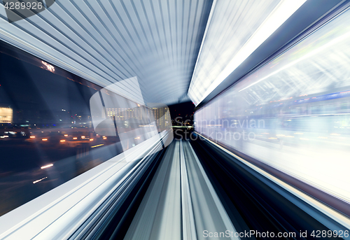 Image of Tunnel in tokyo at night blurred as idea of speed