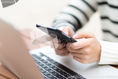 Image of Woman sending text message on cellphone