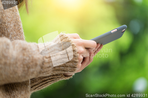 Image of Woman use of cellphone in park