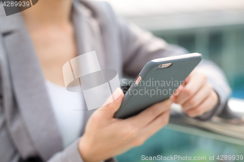 Image of Business woman touch on smartphone