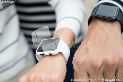 Image of Couple using smart watch together