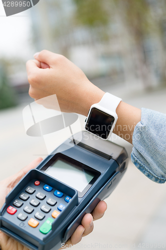 Image of Customer using smart watch to checkout