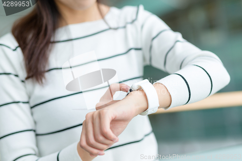 Image of Young woman use of smart watch