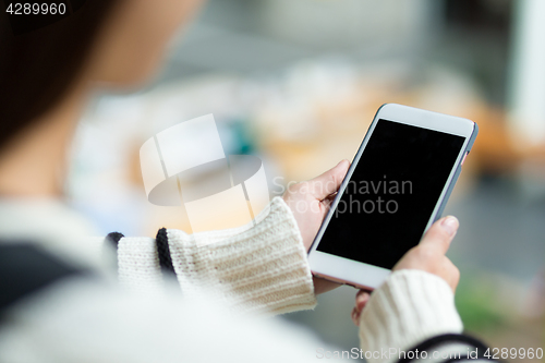 Image of Woman holding the blank screen of cellphone