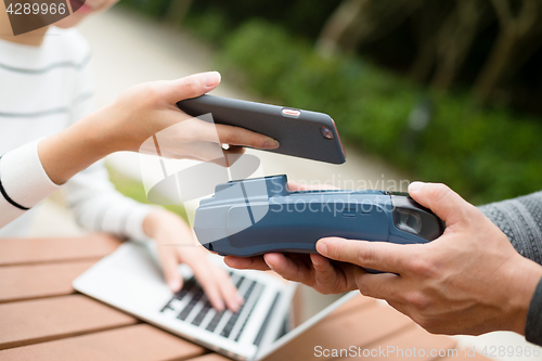 Image of Woman pay on pos machine