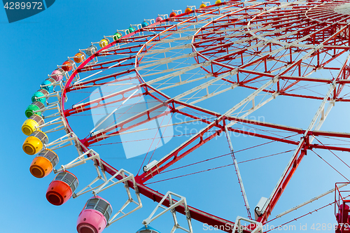 Image of Ferris wheel over blue sky