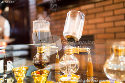 Image of Siphon vacuum coffee maker on cafe bar