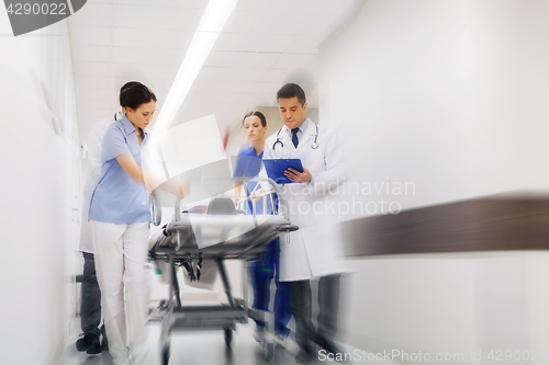 Image of medics and patient on hospital gurney at emergency