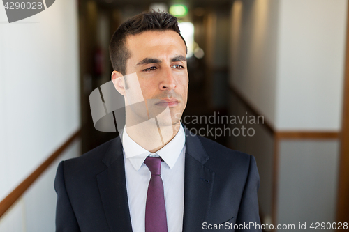 Image of businessman in suit at hotel corridor 
