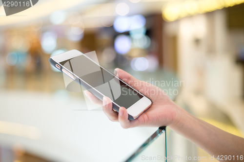 Image of Woman holding on cellphone