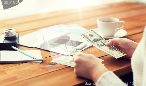 Image of close up of traveler hands counting dollar money