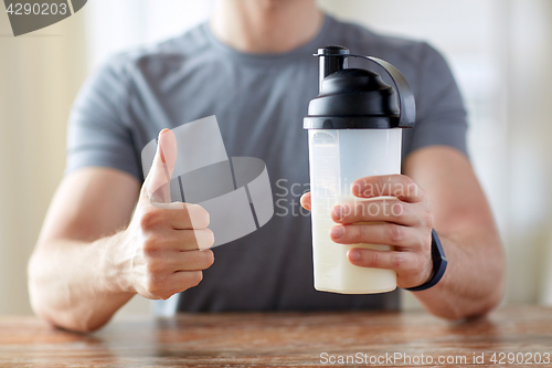 Image of man with protein food showing thumbs up