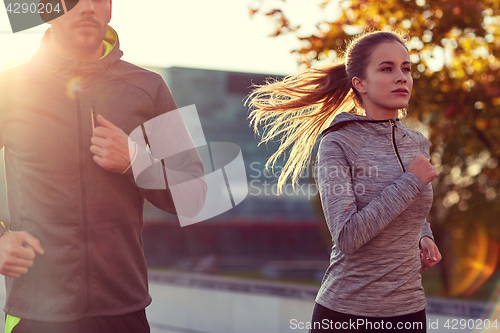 Image of couple running outdoors