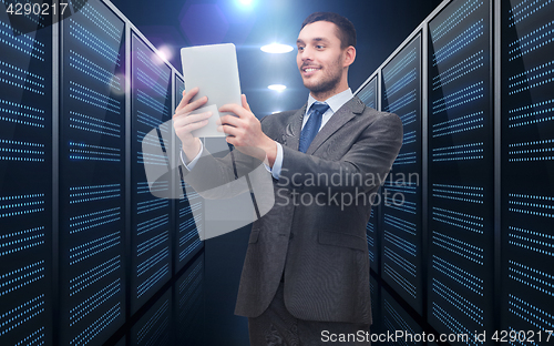 Image of businessman with tablet pc over server room