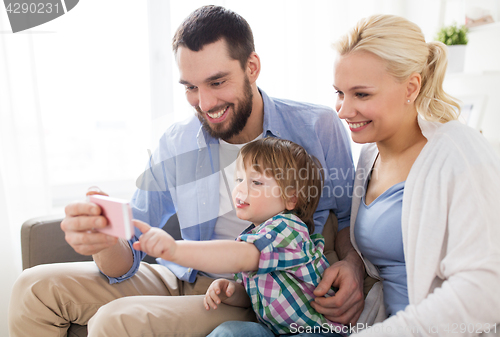 Image of happy family with smartphone at home