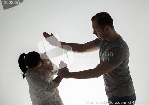 Image of couple having fight and man slapping woman