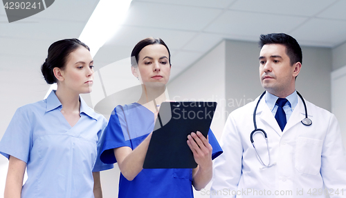 Image of group of medics at hospital with clipboard